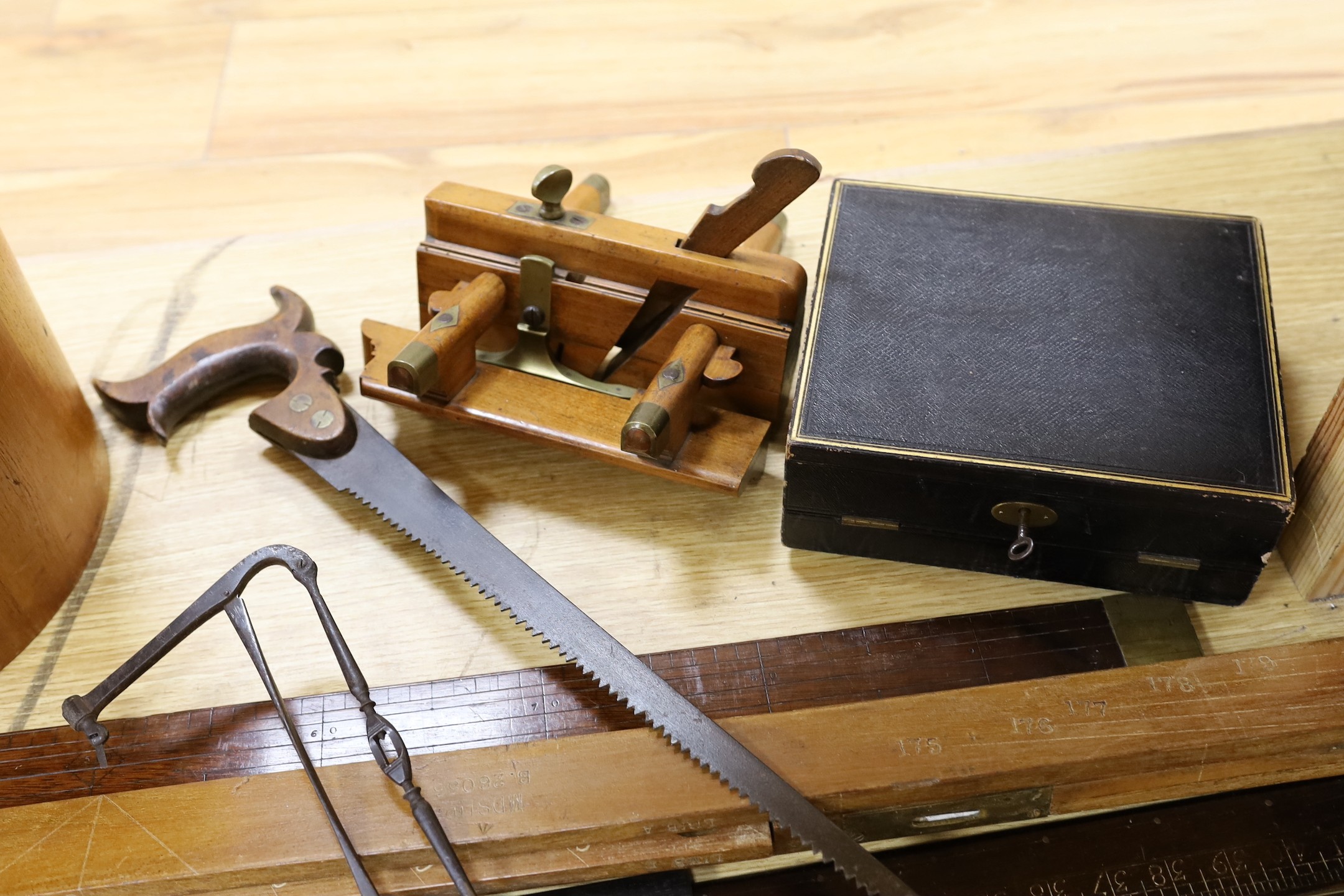 A leather writing box, a collection of wooden rulers, a small collection of wood working and surgeon’s tools etc